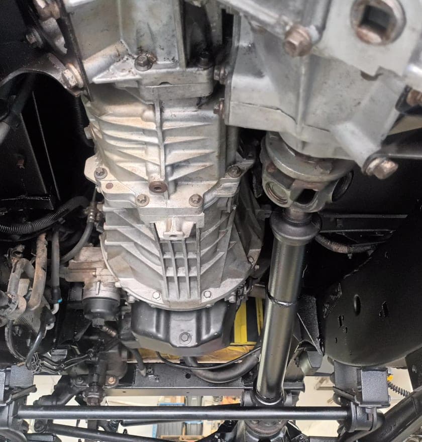Defender transfer case and driveshafts with the coated underbody around them