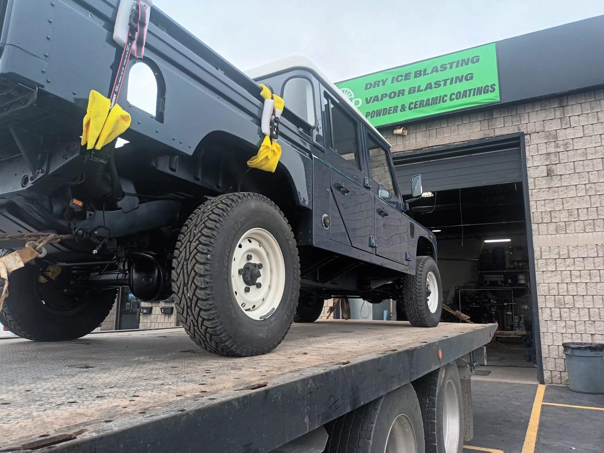 Finished Defender loaded on the flatbed outside the RBSD shop in Hamilton