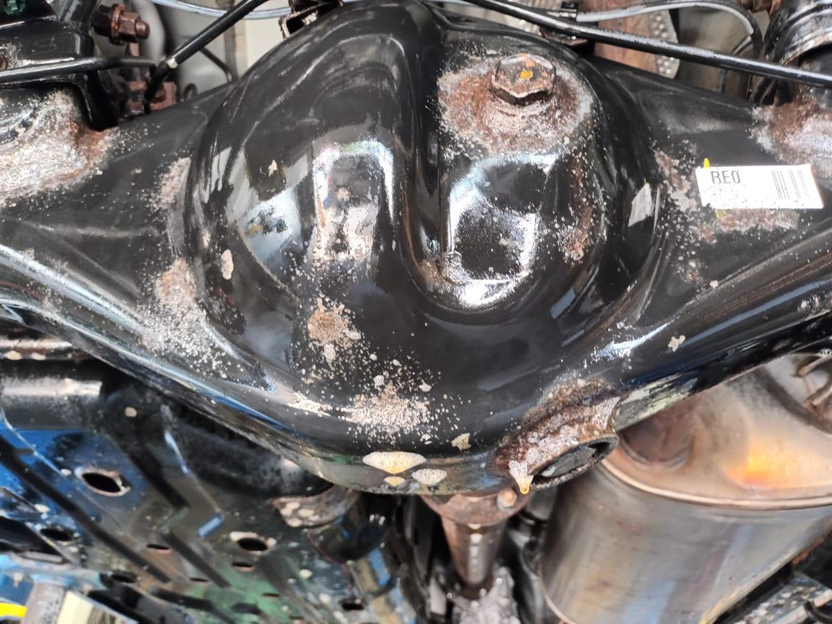 Rust converter sprayed over rusted areas of a 4Runner underbody after blasting